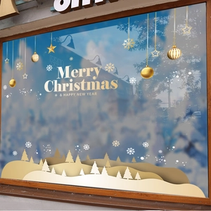 White and gold Christmas window decals with snowflakes, trees and Merry Christmas lettering