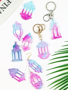 Flat lay of gradient resin lantern earrings and keychains with glitter on white background