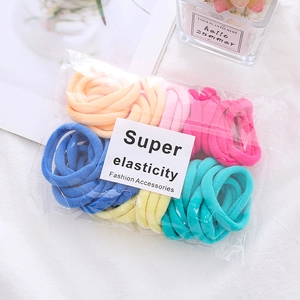 Macro shot of colorful seamless towel hair ties in macaron colors and clear packaging