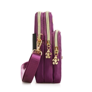 Vertical deep purple nylon crossbody phone bag with three layered zipper compartments