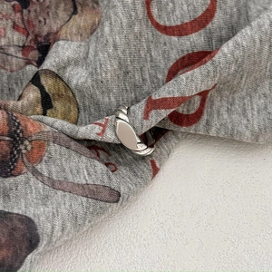 Minimalist 925 sterling silver twisted ring with a polished oval knot on grey fabric