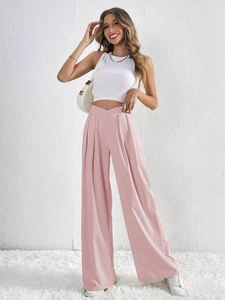 Detailed view of women's pink high-waisted wide leg trousers with a V-shaped waistband