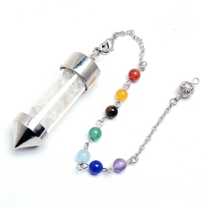 Macro detail of hexagonal crystal bottle pendulum with white quartz chips and chakra beads