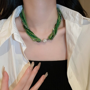 Detail view of multi-layer green crystal bead necklace with a spherical magnetic clasp