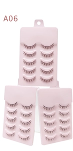 Detailed view of three packs of A06 natural black false eyelashes on pink trays