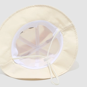 Inside view of baby sun hat showing breathable mesh lining and adjustable chin strap
