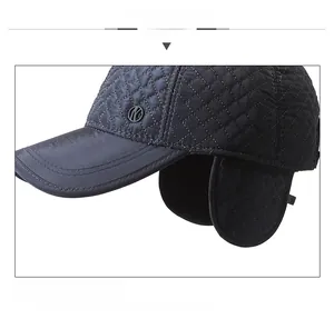 Detail view of winter baseball cap showing quilted diamond pattern and ear protection
