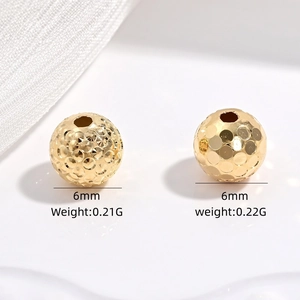 Detail of 6mm gold plated S925 silver beads with faceted and hammered textures
