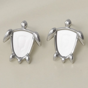 Detailed macro view of 304 stainless steel turtle stud earrings with white turtle shell inlay
