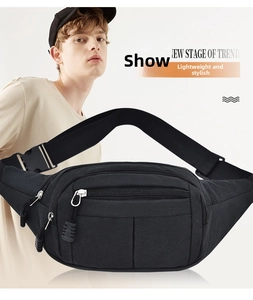 Detail view of the multi-layer zipper pockets and durable nylon strap on the black fanny pack