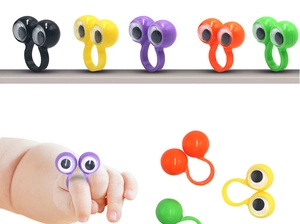 Colorful plastic googly eye rings for kids shown in multiple colors and worn on fingers