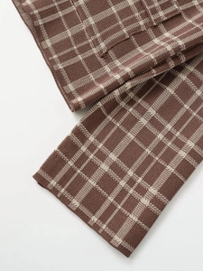 Close-up of brown and beige plaid knit fabric texture showing premium weaving quality