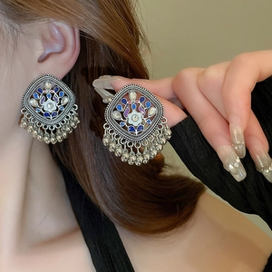 Ethnic style rhombus enamel drop earring with silver fringe on female model