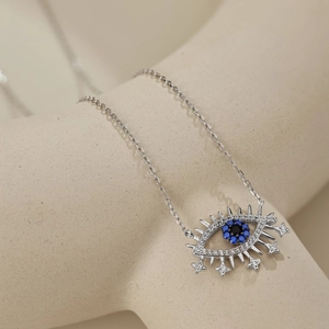Macro shot of S925 sterling silver evil eye necklace with blue gemstone detail