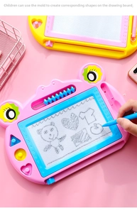 Detail of pink magnetic drawing board with colorful abacus and geometric stamps for kids