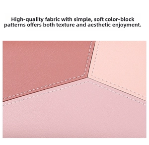 Close-up of color-block leather wallet with litchi grain texture and precise white stitching