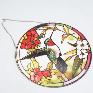 Detail of a hummingbird stained glass acrylic hanging ornament with floral pattern