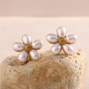 Macro view of 18K gold plated flower stud earrings with white pearl petals and gold center