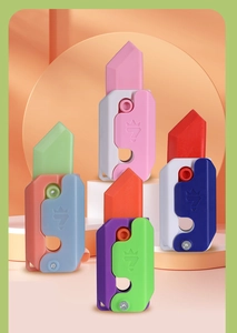 Macro shot of colorful 3D gravity carrot fidget toys in various pastel color schemes