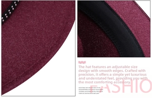 Detail of burgundy wool fedora featuring metal rivets on black ribbon and adjustable sweatband