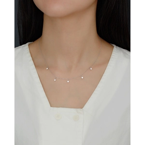 Close-up of elegant S925 silver necklace with five sparkling zircon pendants on a model