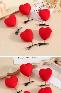 Close-up of red flocked heart hair clip with black spring and metal alligator base