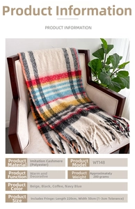 Detail of soft plaid scarf texture with long fringe hanging on a modern beige chair