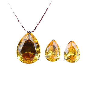 Fashionable jewelry set with pear-cut yellow gemstones and red accented necklace chain
