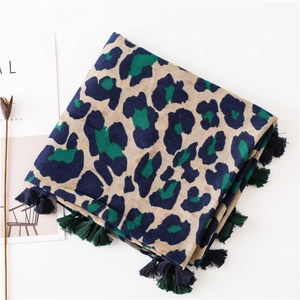 Detail of classic leopard print scarf with textured fabric and multi-color fringe tassels