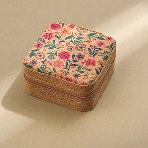 Detail of square cork jewelry box featuring elegant floral patterns and a secure zipper