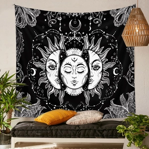 Detail of bohemian sun and moon phases tapestry hanging on a textured white wall