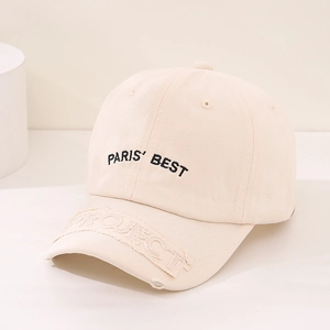 Detail of beige cotton baseball cap with black PARIS' BEST embroidery and project patch