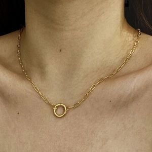 Close-up of 18K gold-plated paperclip chain necklace with round pendant on model
