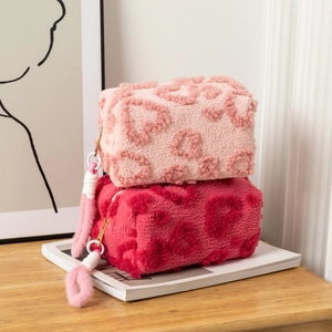 Cute heart patterned plush makeup bags in pink and rose red with gold zippers