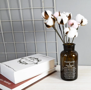 Artificial cotton flower branch in brown glass vase for Nordic home table decoration