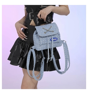 Detail of light blue sequined mini backpack with leather handle and chain closure