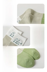 Detail of reinforced heel and elastic cuff with embroidery on green cotton socks