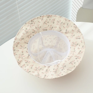 Detail view of baby floral bucket hat showing breathable mesh lining and windproof drawstring