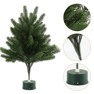 Detailed view of artificial green pine needles and cylinder base of mini Christmas tree