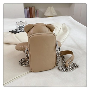 Detail of khaki PU leather bear bag showing smooth texture and metal chain strap