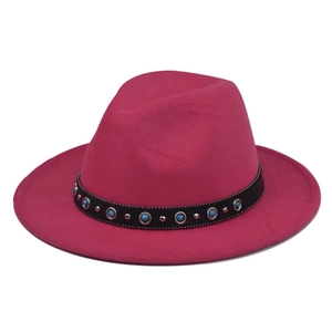 Detail of rose red wool fedora hat featuring black leather band with turquoise and studs