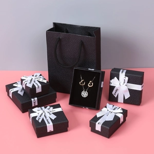 Detailed set of black lychee texture jewelry boxes and matching paper gift bags