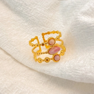 Detail of 18K gold-plated triple-band ring with three pink oval and round natural stones