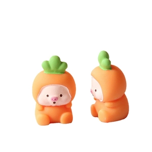 Cute resin mini pig figurines in carrot costumes shown on a clean white background