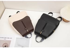 Detail of PU leather backpack with contrast pockets and stylish logo straps