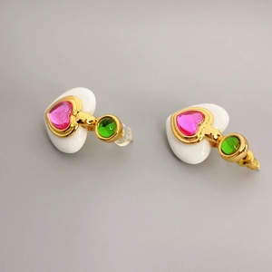 Fashionable heart-shaped drop earrings with white resin, pink gems, and gold accents