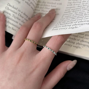 Elegant 925 sterling silver rings with marquise cut green gemstones on open magazine
