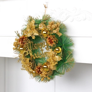 Green Christmas wreath with golden pine cones and Merry Christmas sign on white wall