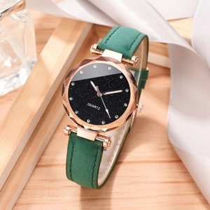 Detail of green leather strap watch with rose gold case and starry sky dial on silk