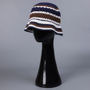 Close-up of handmade crochet bucket hat with blue and brown stripes and hollow design